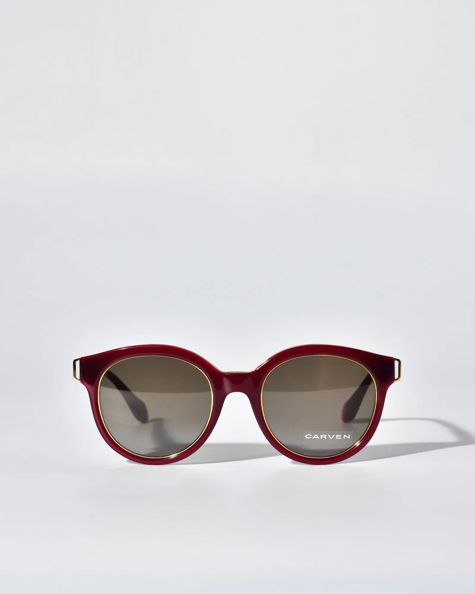 Lunettes rondes en acétate rouge à détails dorés Carven 